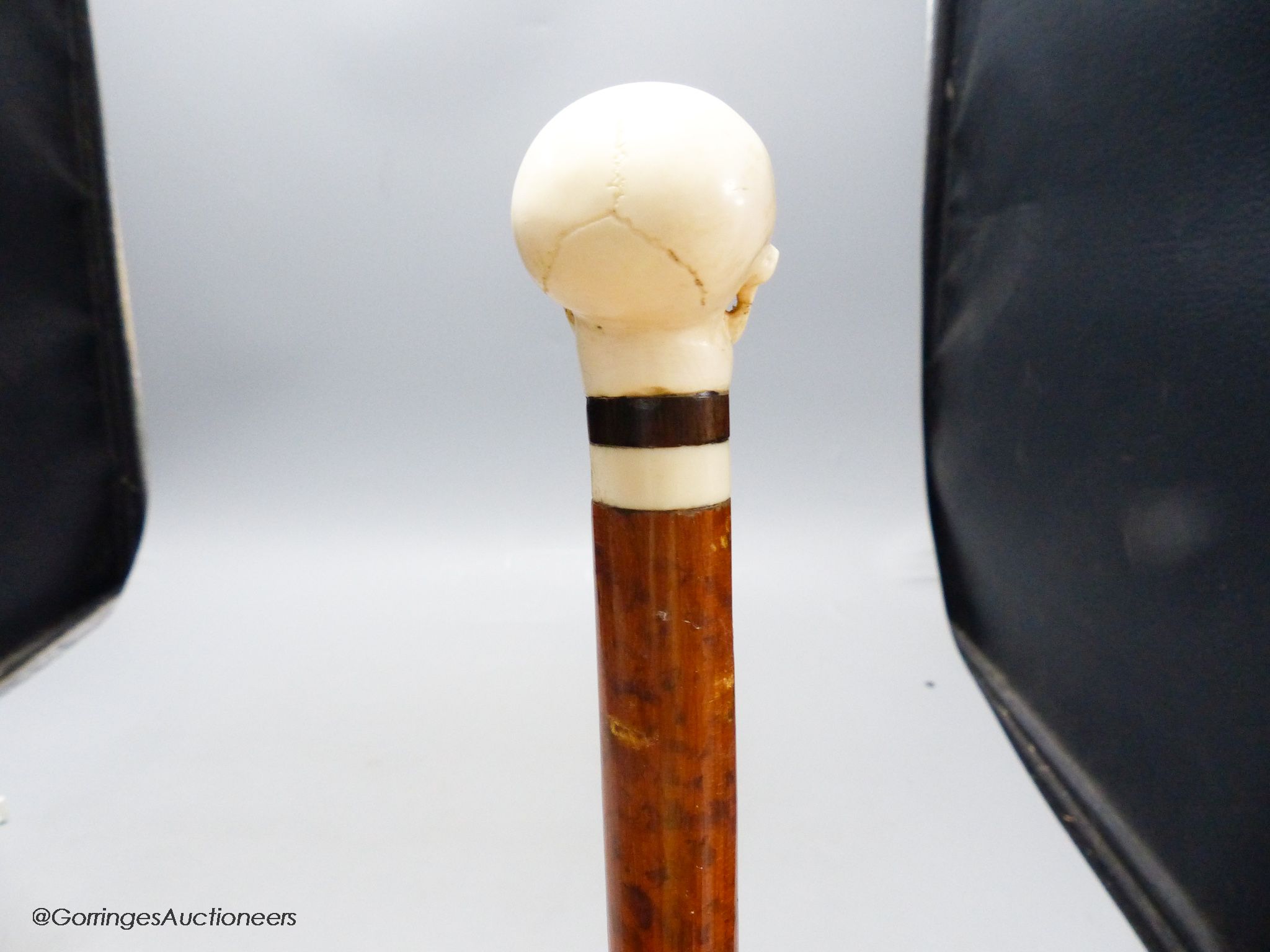A malacca and ivory skull handled walking stick